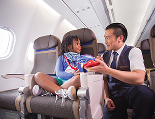 child with flight attendant